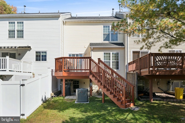 back of house with a wooden deck, a yard, and central air condition unit