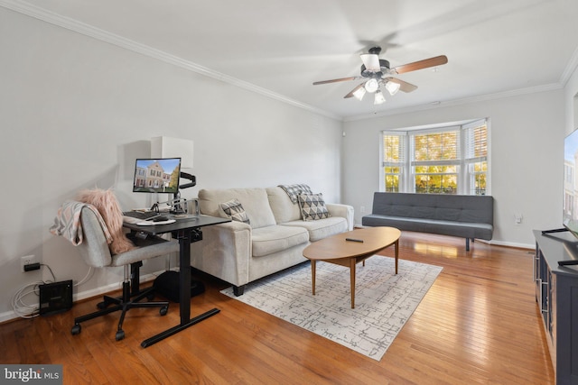 living room featuring ornamental molding, light hardwood / wood-style floors, and ceiling fan