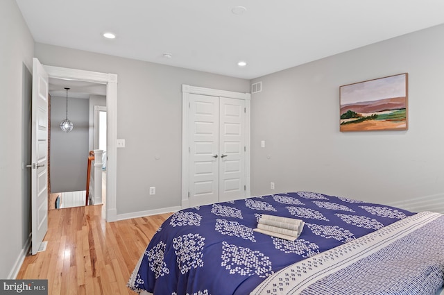 bedroom with hardwood / wood-style flooring and a closet