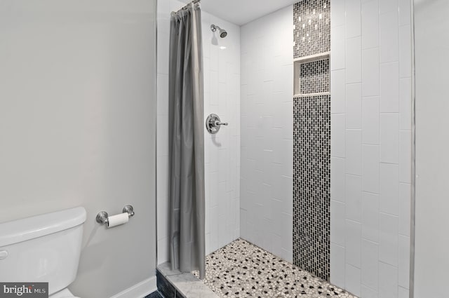 bathroom with walk in shower and toilet