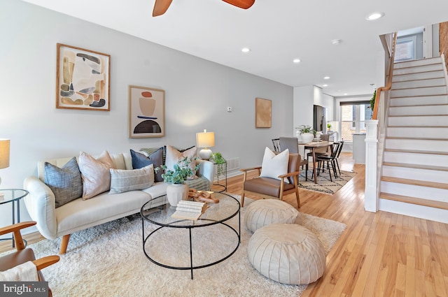 living room with ceiling fan and light hardwood / wood-style floors