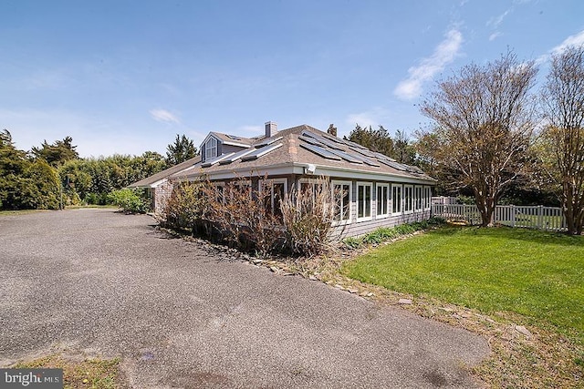 view of side of property featuring a lawn