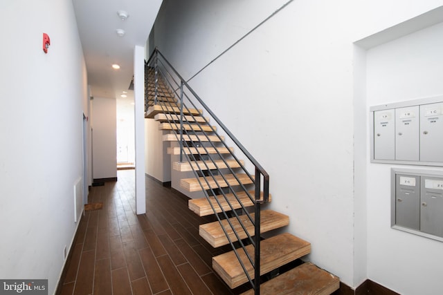 stairs with mail boxes and hardwood / wood-style floors