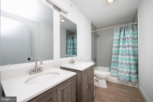 full bathroom with vanity, hardwood / wood-style floors, shower / tub combo with curtain, and toilet