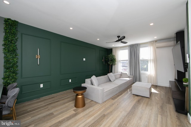 living room featuring ceiling fan and light wood-type flooring