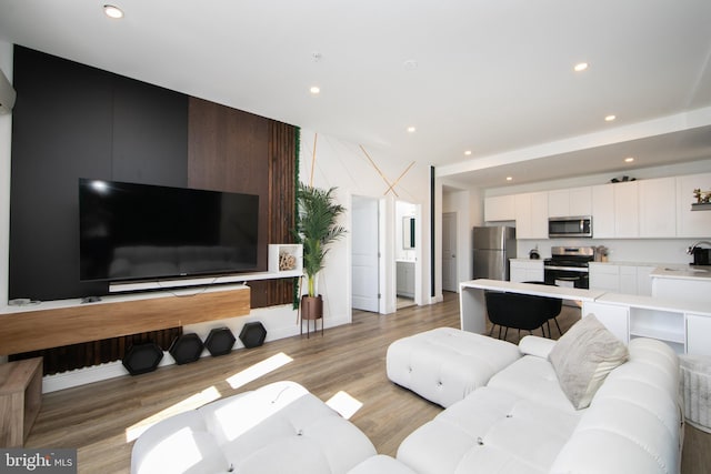 living room with sink and light hardwood / wood-style flooring