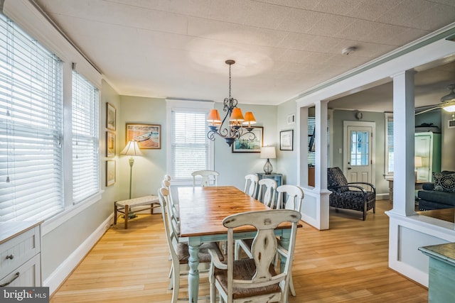 dining area featuring ceiling fan with notable chandelier and light hardwood / wood-style floors