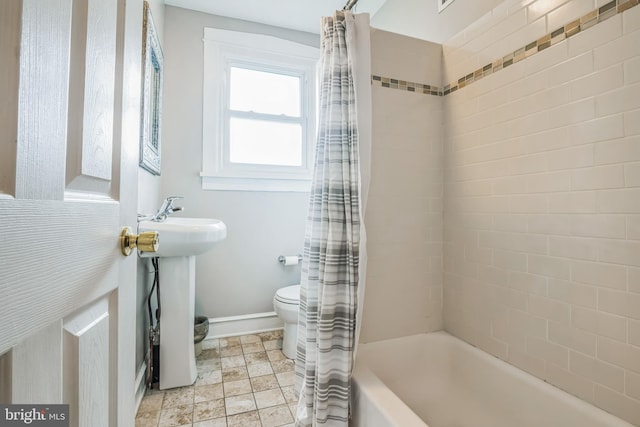 bathroom featuring toilet and shower / bathtub combination with curtain