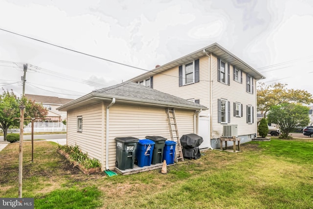 rear view of property with a yard