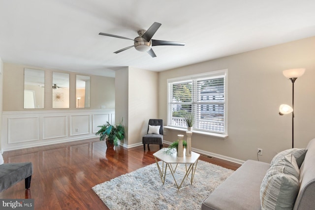 living room with ceiling fan and dark hardwood / wood-style floors