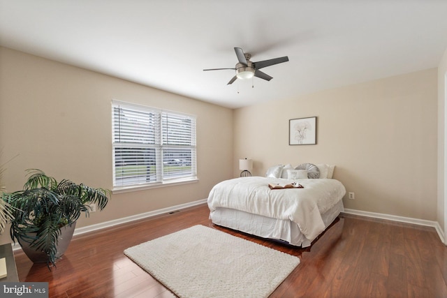 bedroom with dark wood-type flooring and ceiling fan