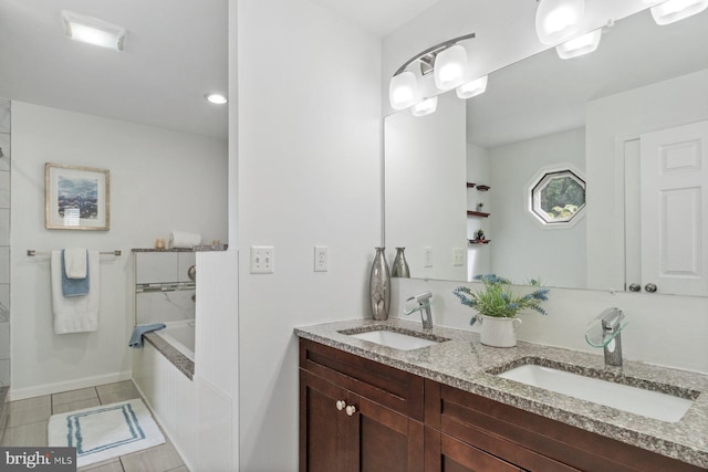 bathroom with vanity, a relaxing tiled tub, and tile patterned floors