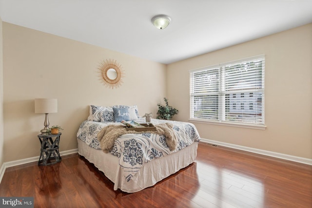 bedroom with dark hardwood / wood-style floors