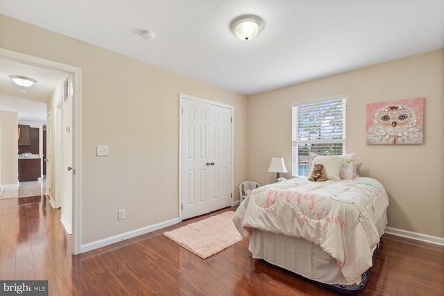 bedroom featuring a closet and dark hardwood / wood-style flooring