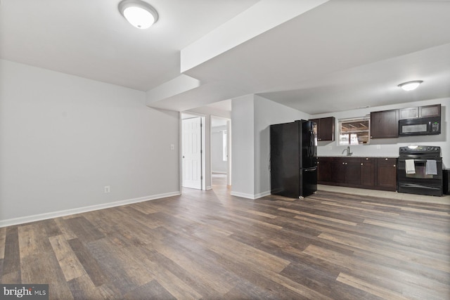 kitchen with sink, black appliances, dark brown cabinetry, and wood-type flooring