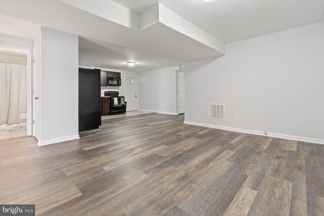 unfurnished living room with dark hardwood / wood-style floors