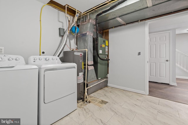 laundry area featuring light hardwood / wood-style floors, electric water heater, and washer and dryer