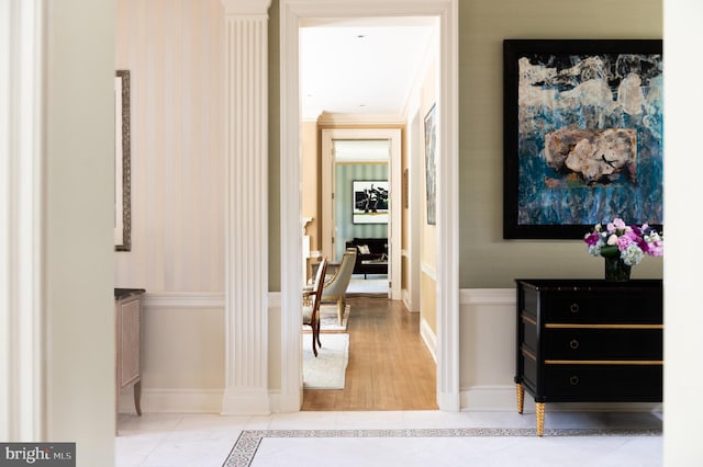 hallway featuring crown molding and light hardwood / wood-style floors