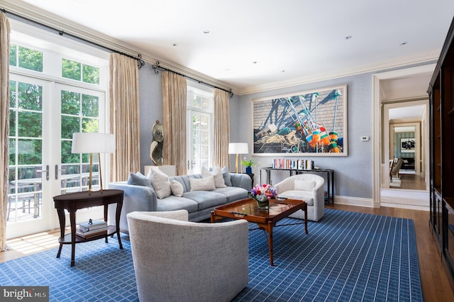 living room featuring dark wood-type flooring, french doors, crown molding, and a healthy amount of sunlight