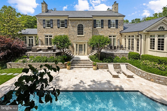 back of property featuring french doors and a patio