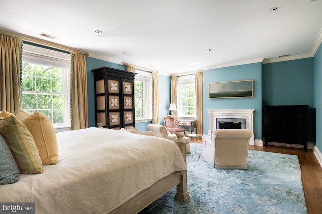 bedroom with multiple windows, crown molding, and dark hardwood / wood-style floors