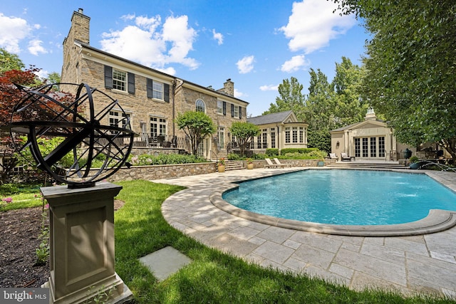 view of swimming pool featuring pool water feature and a patio area