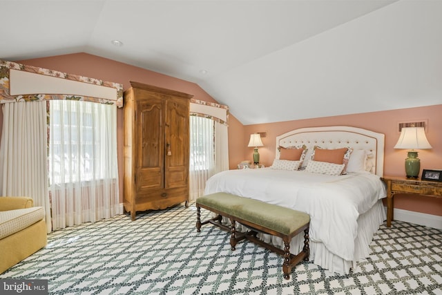 carpeted bedroom with vaulted ceiling