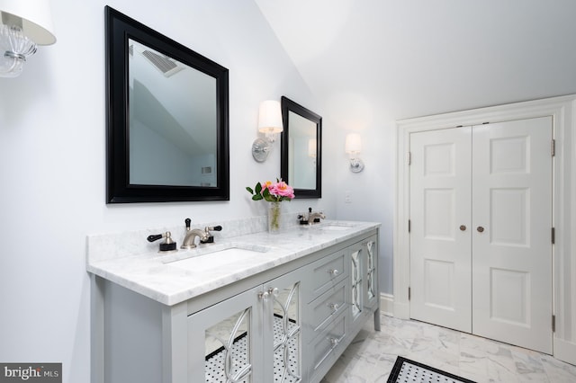 bathroom with vaulted ceiling and vanity