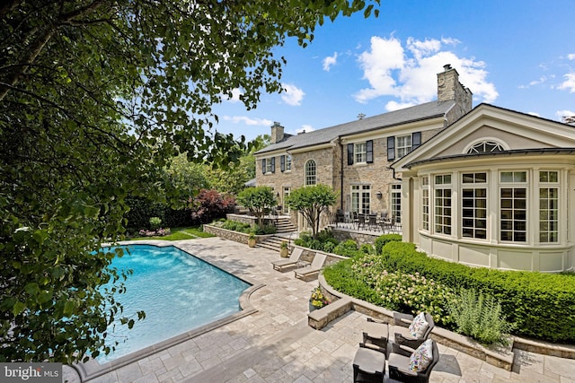 view of swimming pool with a patio