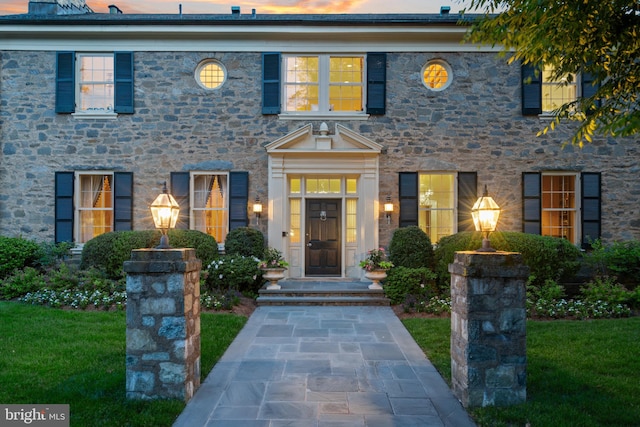 colonial-style house with a lawn