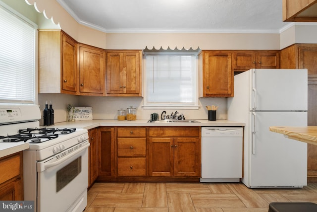 kitchen featuring ornamental molding, sink, and white appliances