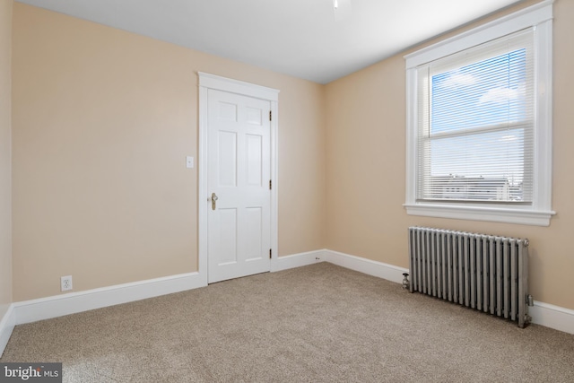 carpeted empty room with radiator