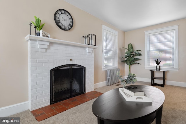 living room featuring dark colored carpet and a brick fireplace