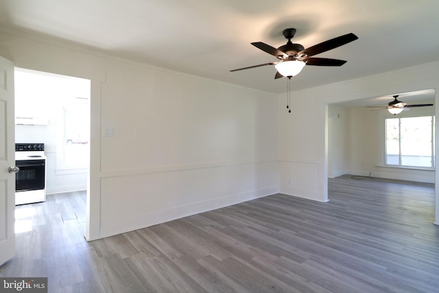 spare room with ceiling fan, hardwood / wood-style floors, and ornamental molding