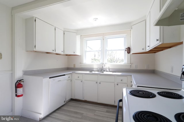 kitchen featuring sink, light hardwood / wood-style floors, white appliances, white cabinets, and exhaust hood