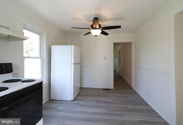 kitchen featuring ceiling fan, extractor fan, white appliances, and light wood-type flooring