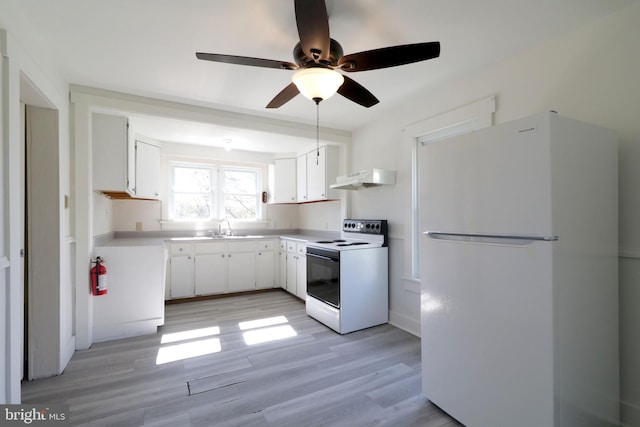 kitchen with light wood-type flooring, white appliances, white cabinetry, and exhaust hood