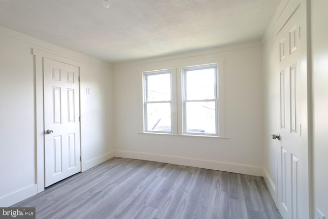 unfurnished bedroom with light wood-type flooring