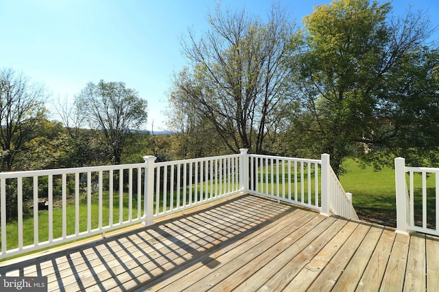 wooden terrace with a lawn