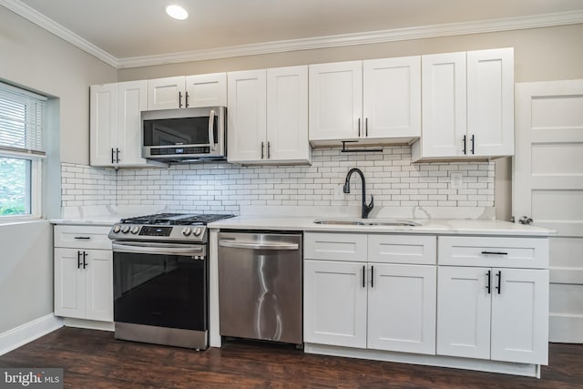 kitchen featuring stainless steel appliances, sink, dark hardwood / wood-style flooring, and white cabinetry