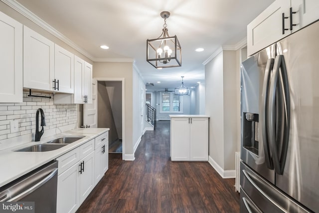 kitchen featuring pendant lighting, white cabinets, sink, dark wood-type flooring, and appliances with stainless steel finishes