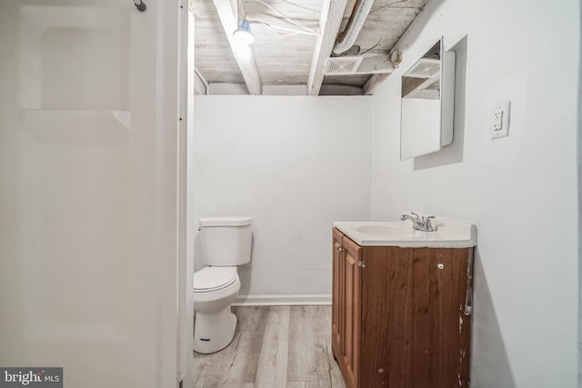 bathroom with hardwood / wood-style floors, vanity, and toilet