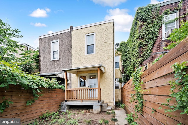 1715 N Felton St, Philadelphia, PA 19151 - rear view of property featuring stucco siding and fence
