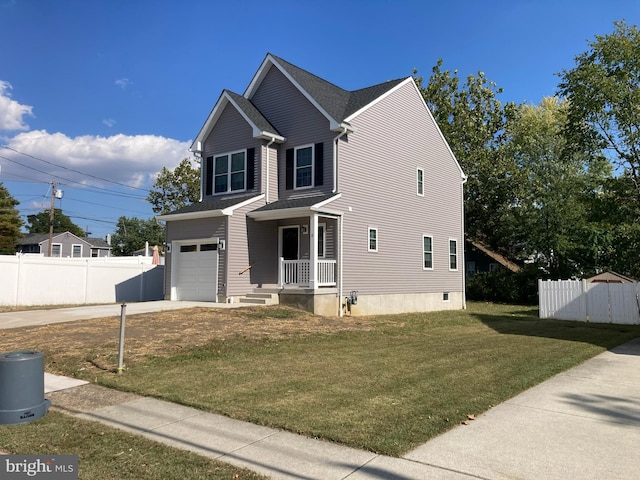 view of front facade featuring a front yard, a garage, and a porch