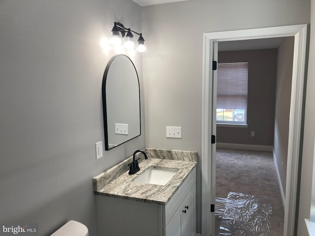 bathroom with toilet and vanity