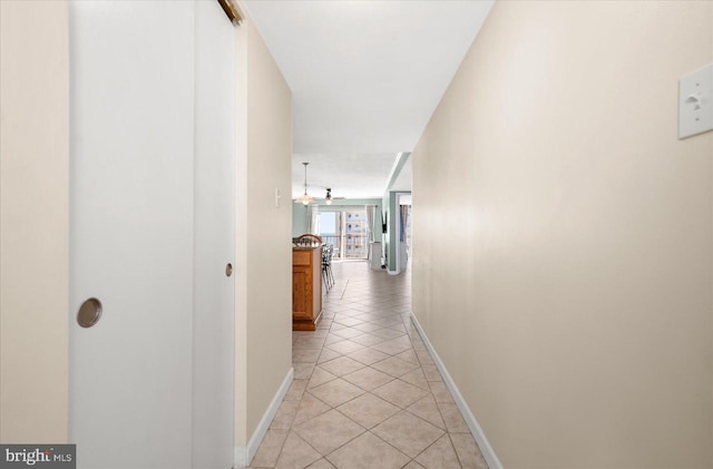 corridor featuring light tile patterned floors