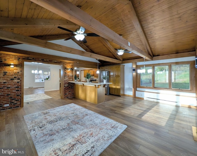 kitchen with wooden ceiling, vaulted ceiling with beams, brick wall, a baseboard heating unit, and decorative light fixtures