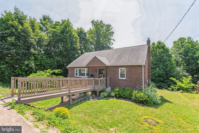 view of front of home featuring a front lawn and a wooden deck