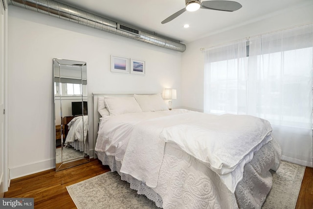 bedroom with ceiling fan and dark wood-type flooring