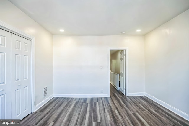 unfurnished room with dark hardwood / wood-style floors